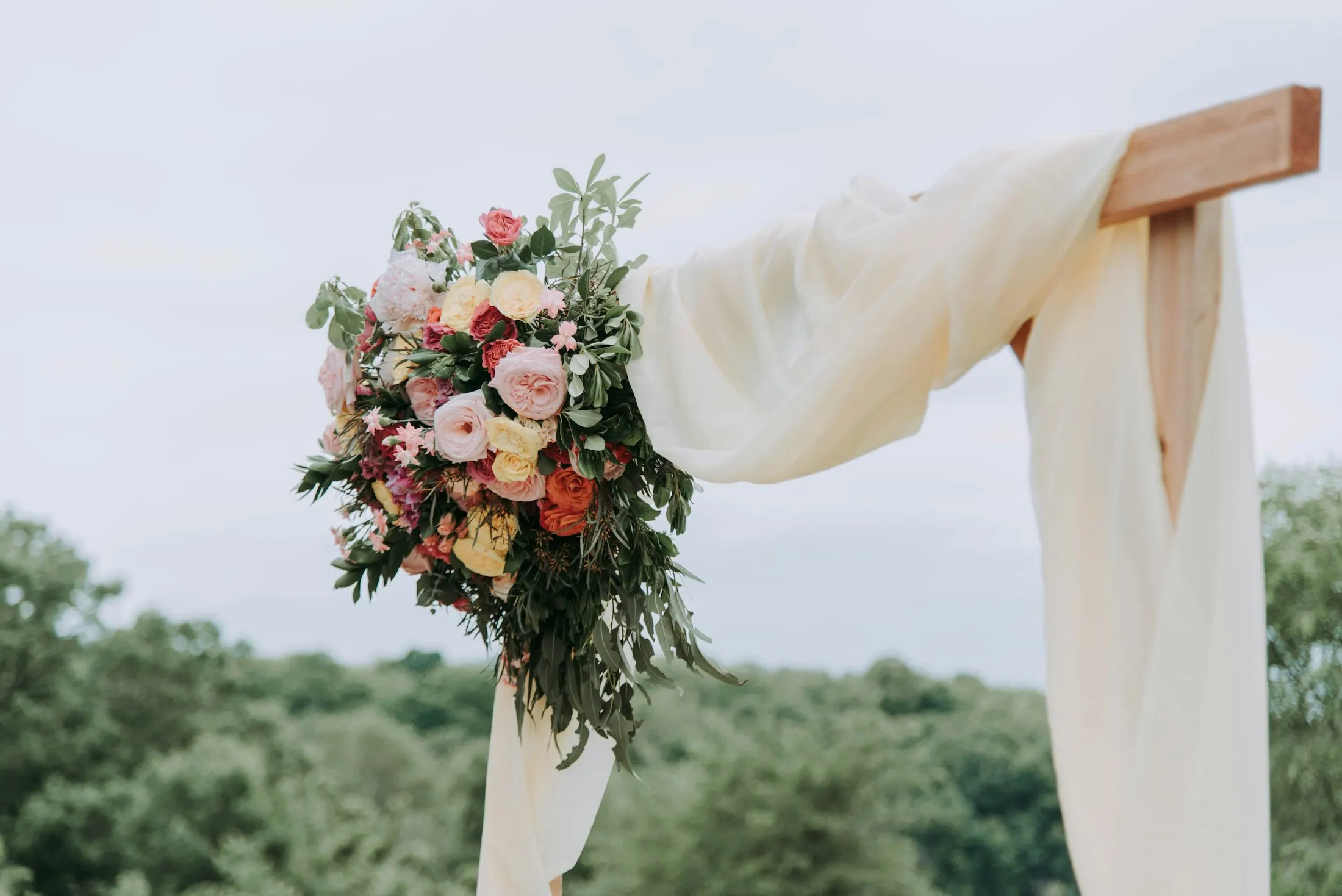 Braut mit großem Rosenbouquet in sanftem Abendlicht